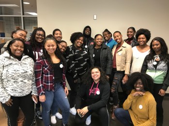 Students wearing big clit energy buttons